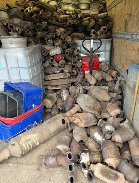 Pile of Used Catalytic Converters Ready for Recycling