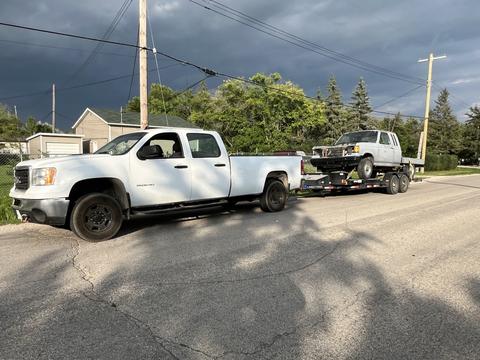 Pickup Truck Hauling Old Vehicle for Scrap Metal Recycling