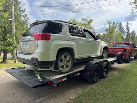 SUV Loaded on Trailer for Scrap Metal Recycling in Manitoba