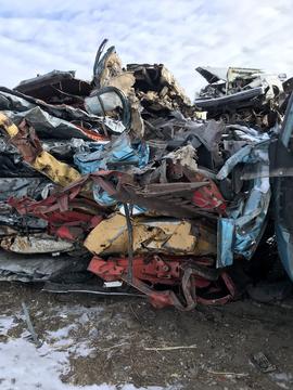 Pile of Crushed Vehicles Ready for Recycling