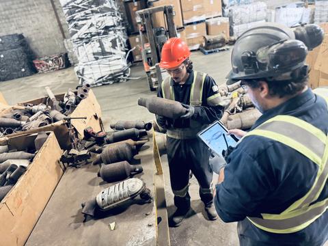 Workers Sorting Catalytic Converters at Scrap Metal Facility