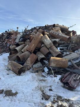 Large Pile of Rusted Metal Pipes at Scrap Yard in Manitoba