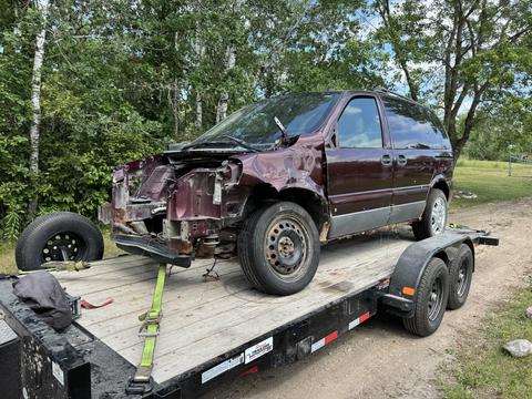 Old Minivan Loaded on Trailer for Scrap Metal Recycling