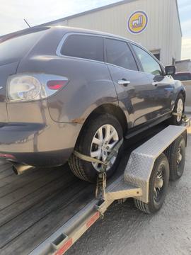 Vehicle Secured on Trailer for Scrap Metal Recycling