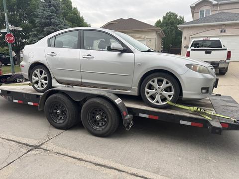Car Loaded on Trailer for Scrap Metal Recycling in Manitoba
