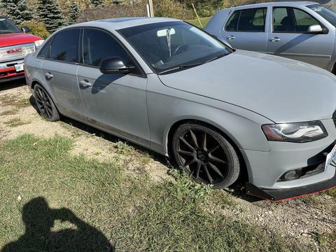 Abandoned Gray Sedan Ready for Scrap Metal Recycling