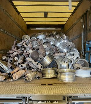 Scrap Metal Collection of Exhaust Parts and Alloy Wheels in Truck