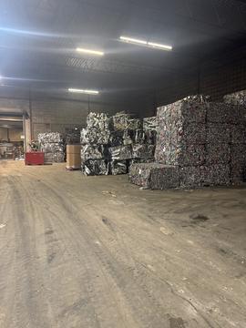 Inside a Scrap Metal Recycling Facility with Stacked Bales