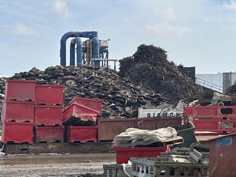 Scrap Metal Recycling Yard with Piles of Metal and Containers